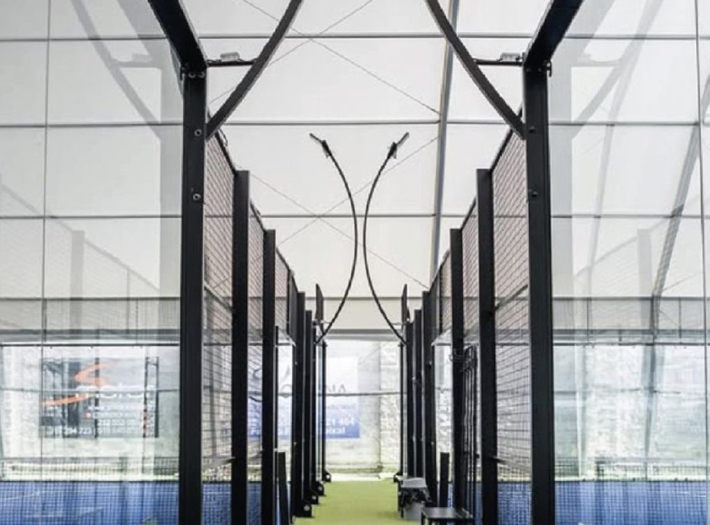 Toshimi Sports indoor covered padel court with black galvanized steel structure and tempered glass